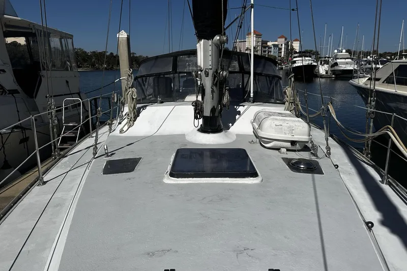 Slide: The Image of 1975 Morgan Out Island 51 sailboat docked in marina, showcasing deck and rigging. - 4