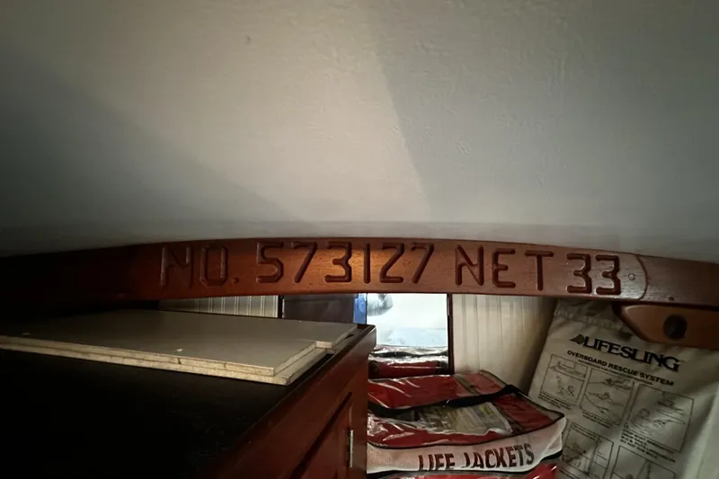 Slide: The Image of Interior of 1975 Morgan Out Island 51 with life jackets and engraved wood beam. - 40