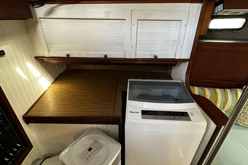 Slide: The Image of 1975 Morgan Out Island 51 interior with washing machine and wooden cabinetry. - 43