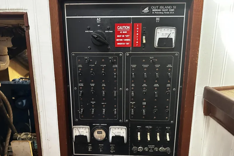 Slide: The Image of Electrical control panel of a 1975 Morgan Out Island 51 yacht, featuring switches and gauges. - 46