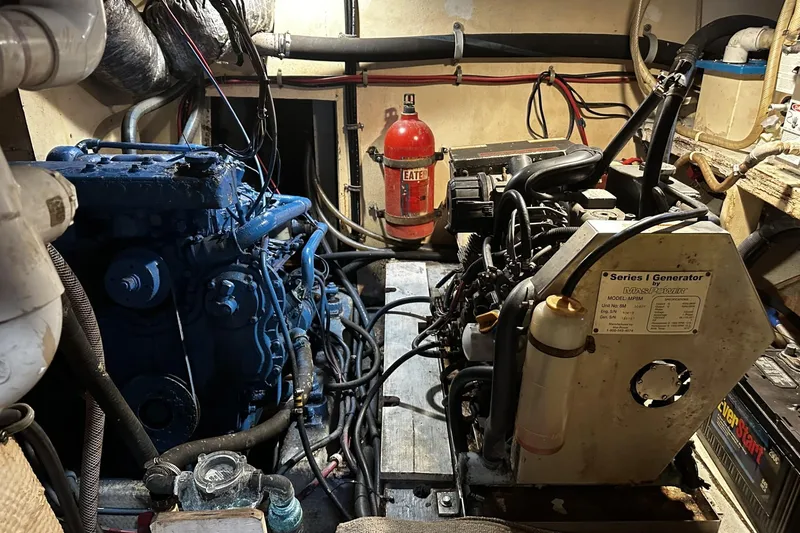 Slide: The Image of Engine room of a 1975 Morgan Out Island 51 sailboat with generator and fire extinguisher. - 47