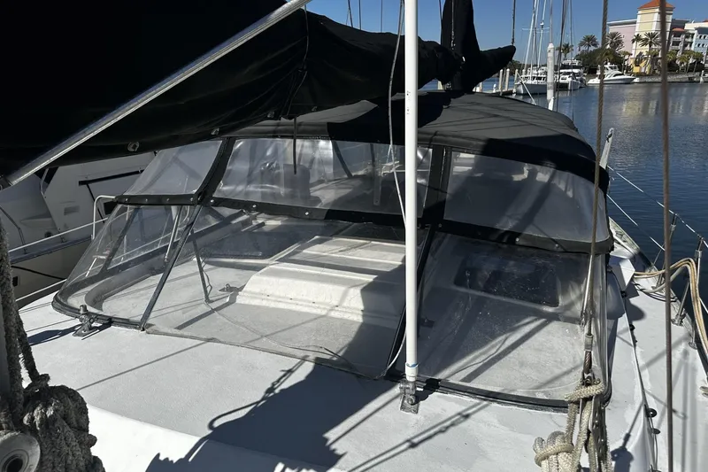 Slide: The Image of 1975 Morgan Out Island 51 sailboat with covered cockpit, docked in a marina. - 5