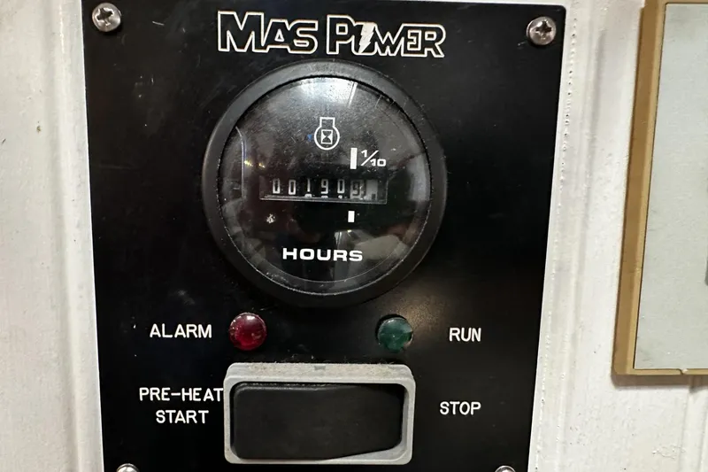 Slide: The Image of Control panel of a 1975 Morgan Out Island 51 boat, featuring hour meter and indicators. - 50