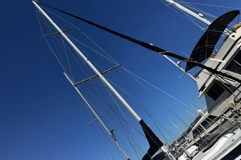 Slide: The Image of Sailboat mast of 1975 Morgan Out Island 51 against clear blue sky. - 55