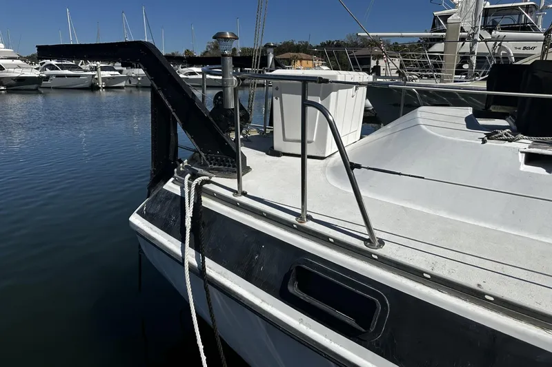 Slide: The Image of 1975 Morgan Out Island 51 sailboat docked in a marina, featuring deck and railing. - 61