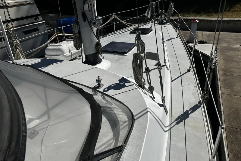 Slide: The Image of 1975 Morgan Out Island 51 sailboat deck with rigging and equipment in marina. - 7