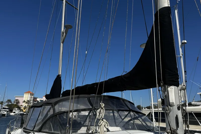 Slide: The Image of 1975 Morgan Out Island 51 sailboat with covered sails docked at marina. - 8