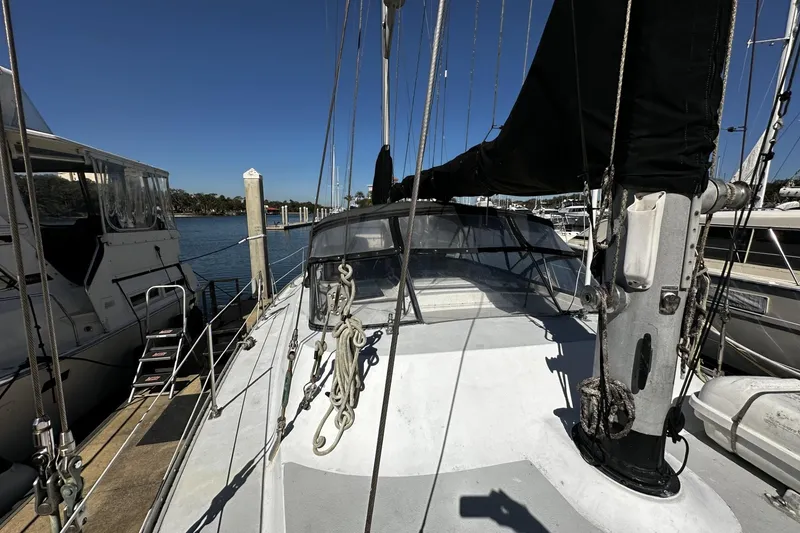 Slide: The Image of 1975 Morgan Out Island 51 sailboat docked at marina under clear blue sky. - 9