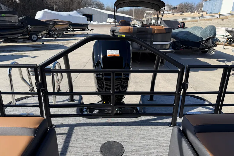 Slide: The Image of 2026 Sylvan L-1 LZ DH pontoon boat with motor, docked outdoors. - 14