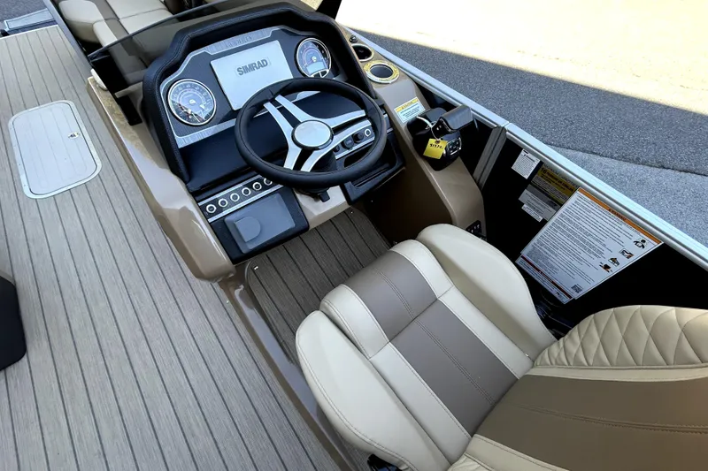 Slide: The Image of 2026 Godfrey Monaco 255 ULC boat cockpit with steering wheel and dashboard controls. - 12