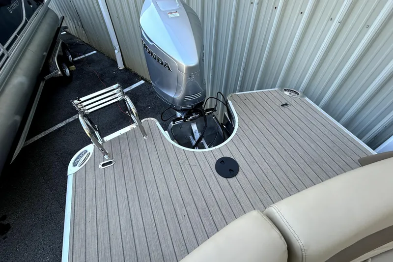 Slide: The Image of 2026 Godfrey Monaco 255 ULC boat with Honda outboard motor and swim ladder. - 15