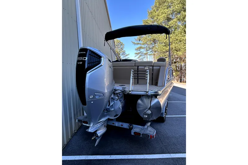 Slide: The Image of 2026 Godfrey Monaco 255 ULC pontoon boat with Honda 350 V8 engine, parked outdoors. - 3