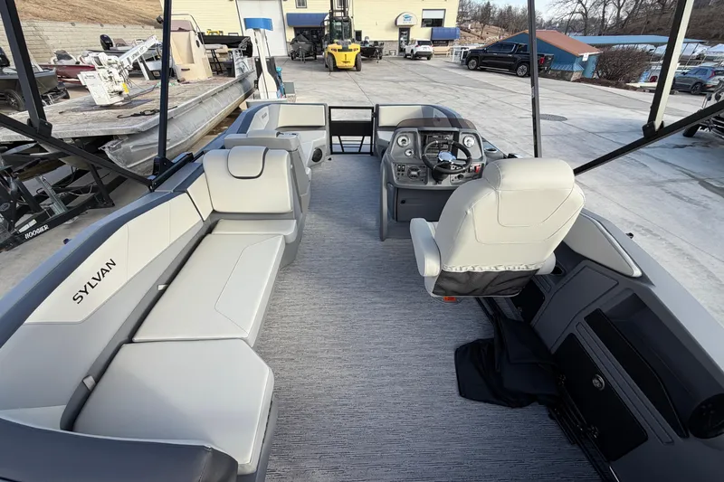 Slide: The Image of 2026 Sylvan A-18 boat interior with modern seating and steering console. - 5