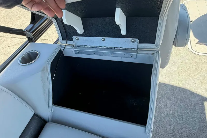 Slide: The Image of Open storage compartment in 2020 Avalon GS Quad Lounger boat with cup holder. - 16
