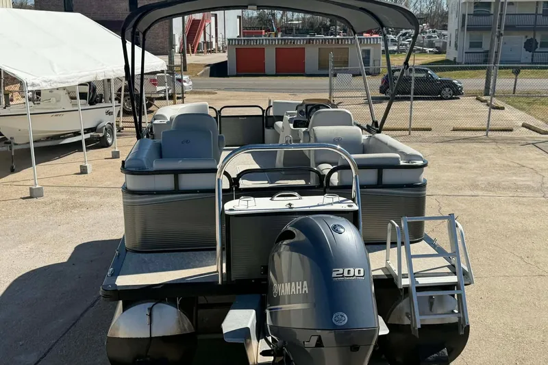 Slide: The Image of 2020 Avalon GS Quad Lounger 23' pontoon boat with Yamaha 200 engine, docked outdoors. - 8