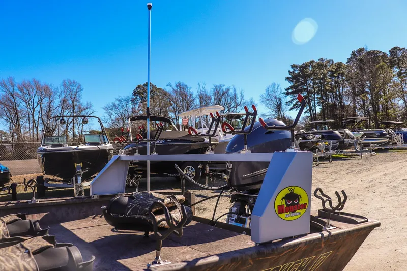 Slide: The Image of 2024 G3 Gator Tough 17 SC boat with Monster rod holders in a sunny outdoor setting. - 12