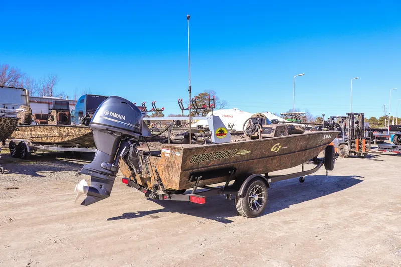 Slide: The Image of 2024 G3 Gator Tough 17 SC boat with Yamaha motor on trailer, outdoor setting. - 2