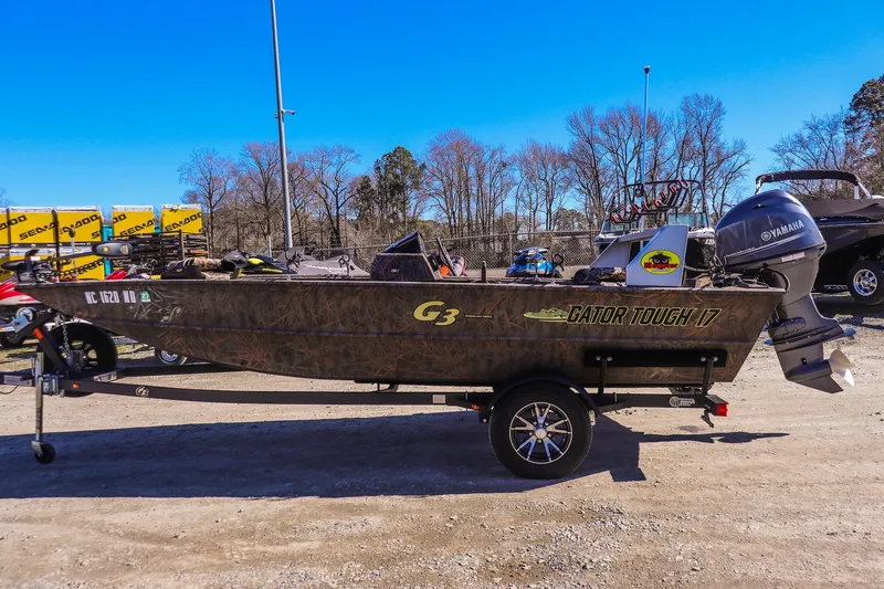 Slide: The Image of 2024 G3 Gator Tough 17 SC boat with Yamaha motor, parked outdoors. - 5
