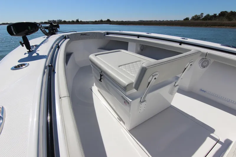 Slide: The Image of 2024 Front Runner 33 Center Console boat on water, showcasing fishing rod holders. - 12