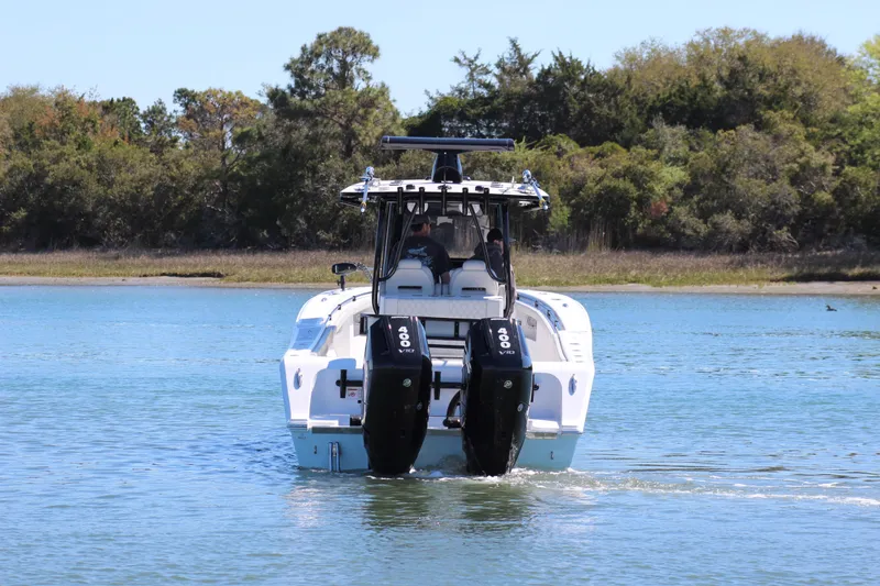 Slide: The Image of 2024 Front Runner 33 Center Console boat cruising on a calm lake. - 6