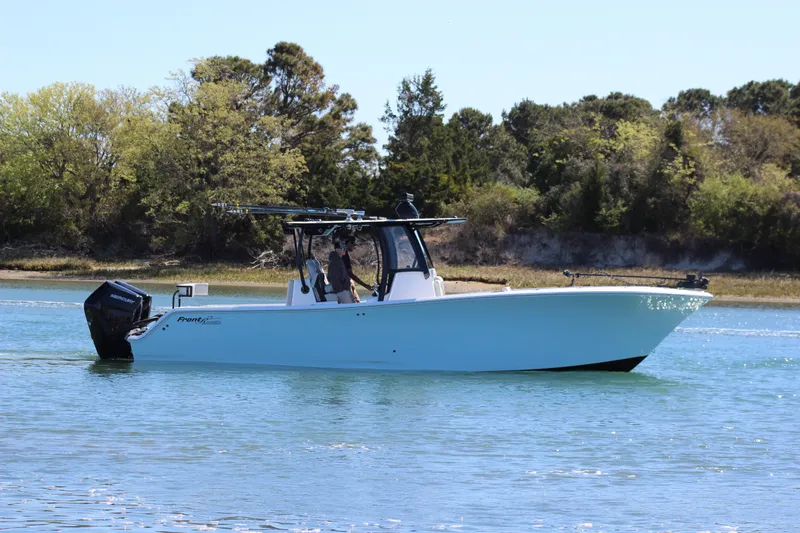 Slide: The Image of 2024 Front Runner 33 Center Console boat on calm water, showcasing sleek design and spacious deck. - 8