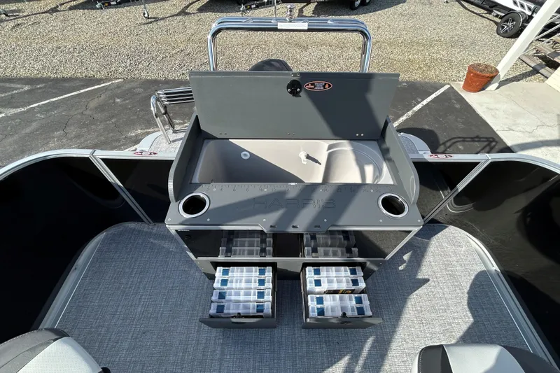 Slide: The Image of 2026 Harris Cruiser 210 boat interior with storage compartments and sink. - 15