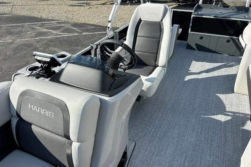 Slide: The Image of 2026 Harris Cruiser 210 boat interior with modern seating and steering console. - 17