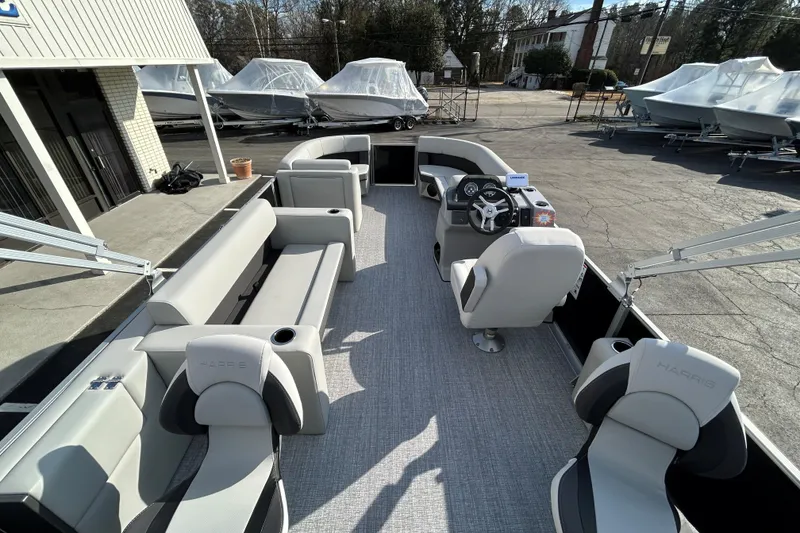 Slide: The Image of 2026 Harris Cruiser 210 pontoon boat interior with modern seating and steering console. - 18