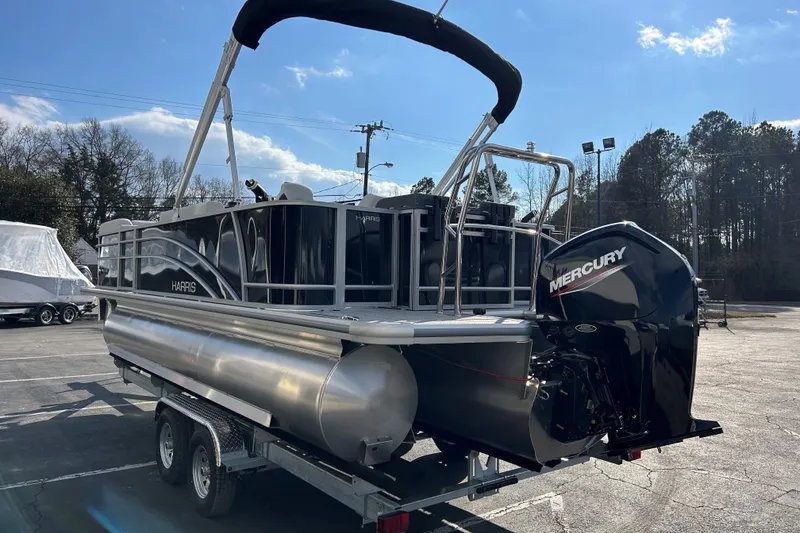 Slide: The Image of 2026 Harris Cruiser 210 pontoon boat with Mercury engine on a trailer. - 4