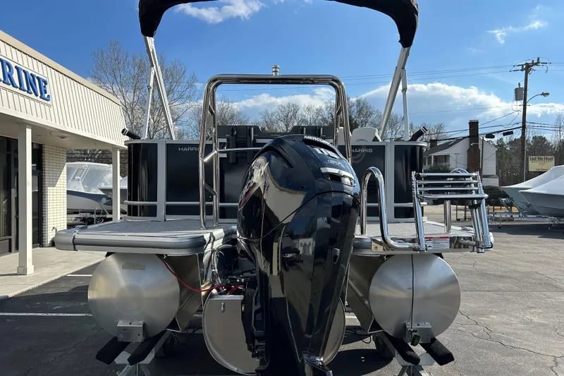 Slide: The Image of 2026 Harris Cruiser 210 pontoon boat with Mercury engine at a marina. - 5