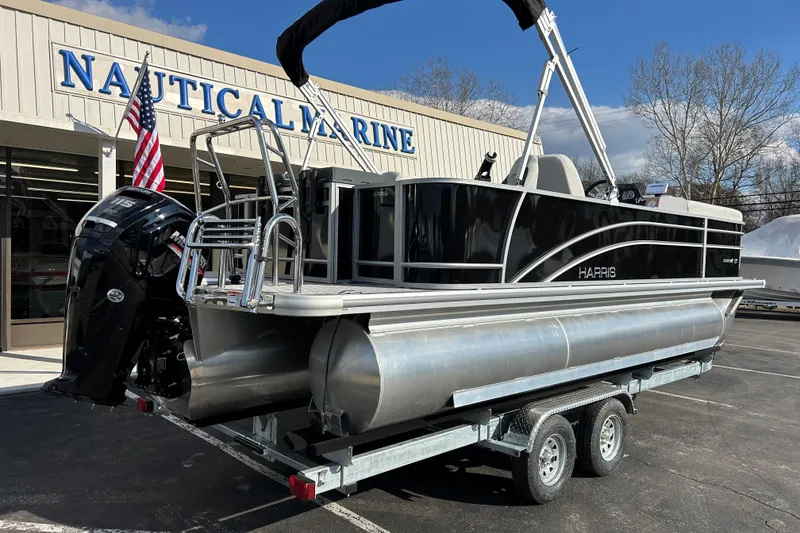 Slide: The Image of 2026 Harris Cruiser 210 pontoon boat on trailer at Nautical Marine dealership. - 6