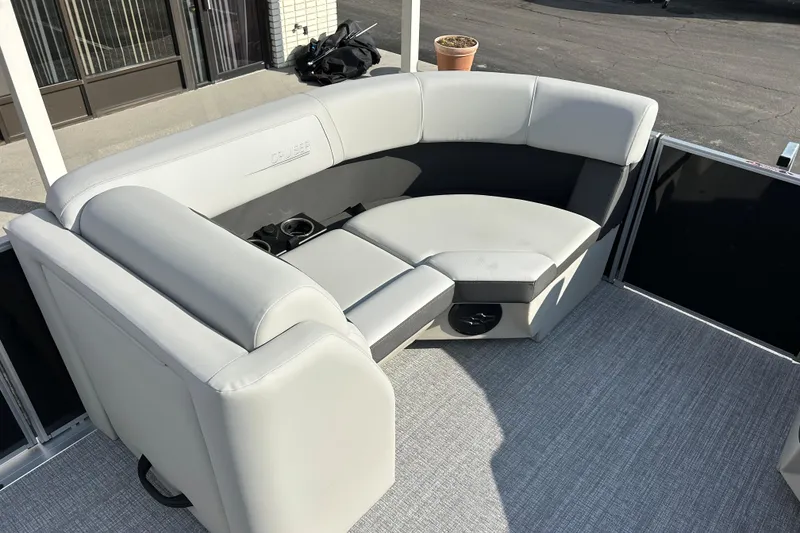 Slide: The Image of Luxurious seating on 2026 Harris Cruiser 210 pontoon boat, featuring plush gray upholstery. - 7