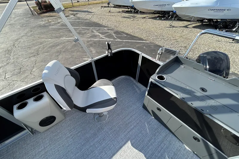 Slide: The Image of 2026 Harris Cruiser 210 boat interior with captain's chair and control panel. - 9