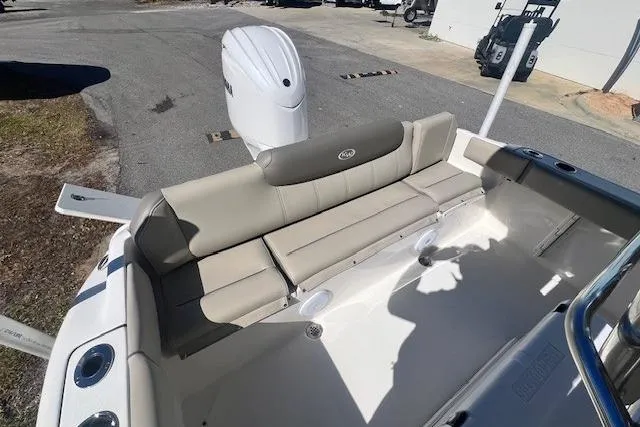Slide: The Image of 2024 Key West 219 FS boat interior with beige seating and outboard motor. - 12