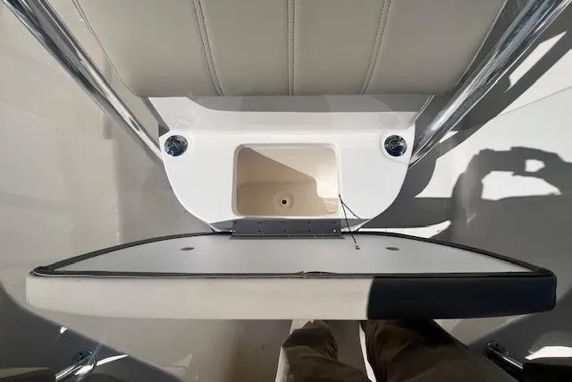 Slide: The Image of 2024 Key West 219 FS boat interior detail with storage compartment and seating. - 15