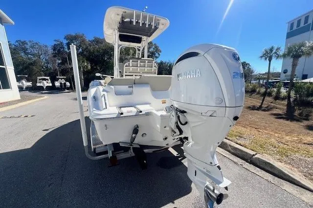 Slide: The Image of 2024 Key West 219 FS boat with Yamaha engine, parked outdoors on a sunny day. - 3