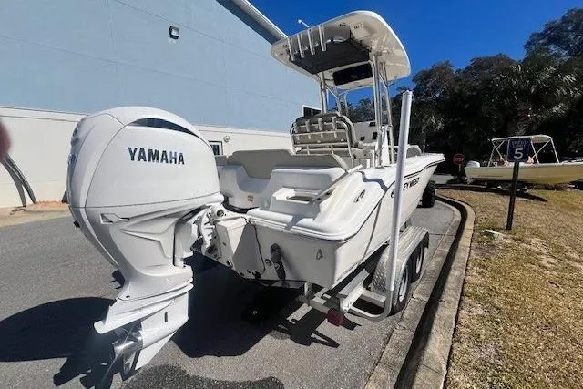 Slide: The Image of 2024 Key West 219 FS boat with Yamaha engine on a trailer, parked outdoors. - 4