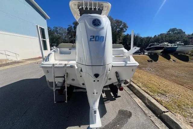 Slide: The Image of 2024 Key West 219 FS boat with powerful 200 HP engine, parked outdoors. - 5