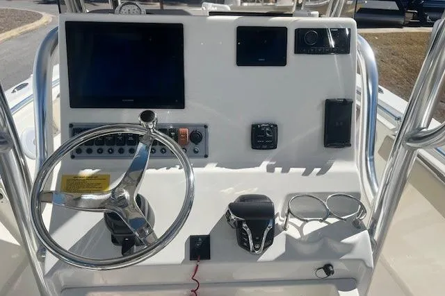 Slide: The Image of 2024 Key West 219 FS boat dashboard with steering wheel and electronic controls. - 6