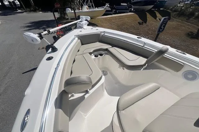 Slide: The Image of 2024 Key West 219 FS boat interior with cushioned seating and fishing rod holder. - 7