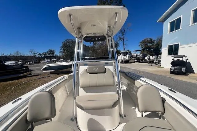 Slide: The Image of 2024 Key West 219 FS boat with T-top and seating, docked outdoors. - 8