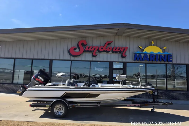 The Image of 2000 Skeeter SX180 boat on trailer outside Sundown Marine store. - 0