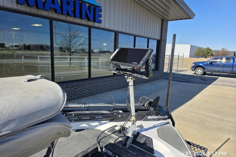Slide: The Image of 2000 Skeeter SX180 boat with MotorGuide trolling motor outside marine store. - 11