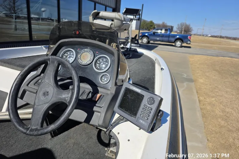 Slide: The Image of 2000 Skeeter SX180 boat dashboard with steering wheel and navigation system. - 9