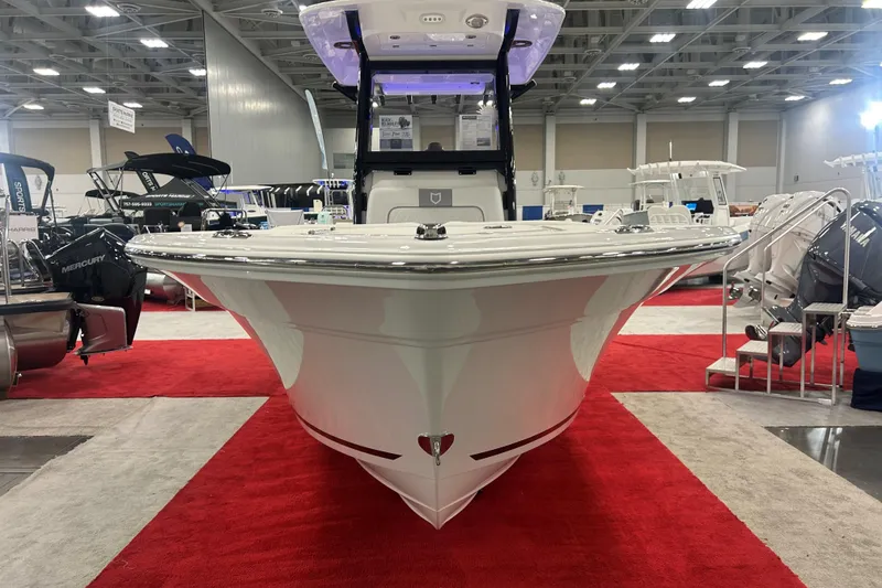 Slide: The Image of 2026 Sea Fox 228 Commander boat displayed at an indoor boat show. - 1
