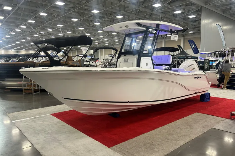 Slide: The Image of 2026 Sea Fox 228 Commander boat displayed at an indoor exhibition on a red carpet. - 2