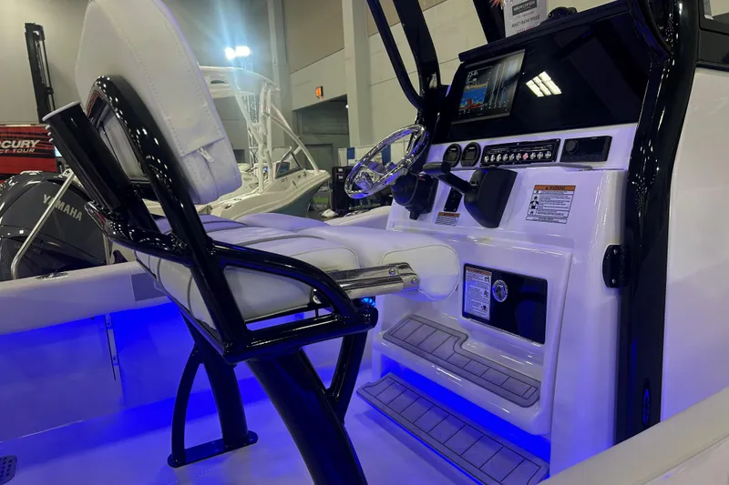 Slide: The Image of 2026 Sea Fox 228 Commander boat interior with illuminated console and seating. - 5