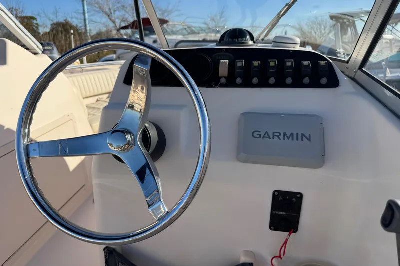Slide: The Image of Steering wheel and dashboard of 2006 Grady-White Tournament 185 boat with Garmin device. - 10
