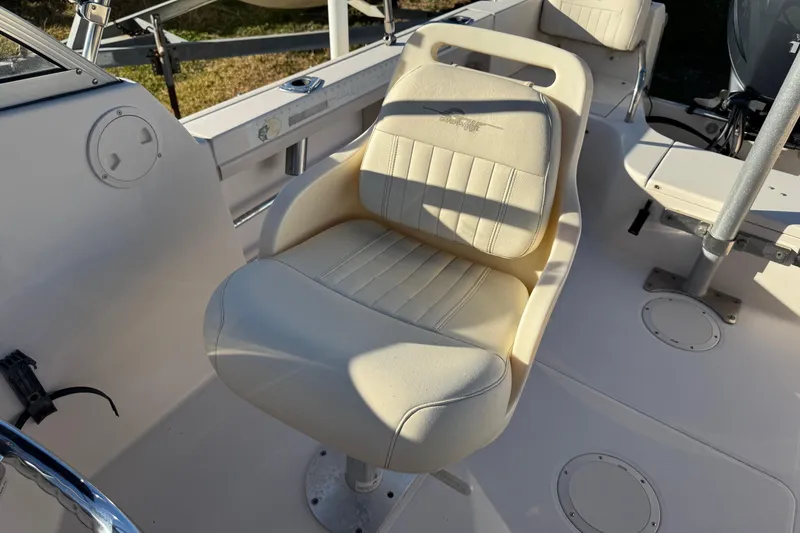 Slide: The Image of 2006 Grady-White Tournament 185 boat seat, cream-colored, with steering wheel visible. - 15