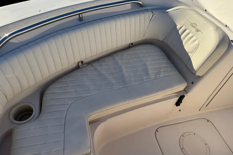 Slide: The Image of 2006 Grady-White Tournament 185 boat seating area with white upholstery and cup holder. - 17